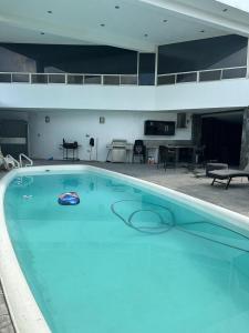 a large blue swimming pool in a building at Residencia en Apodaca Nuevo León in Monterrey