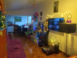 a living room with christmas trees and christmas lights at Siren's House in Cusco
