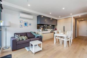 a living room with a couch and a table at 2 Bed Apt with CAR Parking in SouthYarra（TF150221） in Melbourne