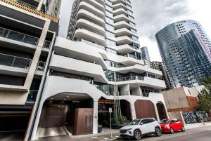 a car parked in front of a tall building at 2 Bed Apt with CAR Parking in SouthYarra（TF150221） in Melbourne