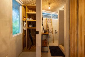 a tiny house with a hallway with a door at Norte Nosara - Steps to Playa Guiones in Nosara