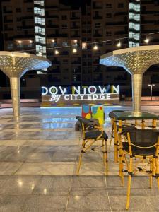 a table and chairs in a city at night at Down town new El alamein in El Alamein