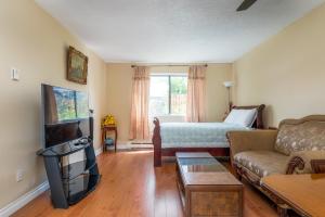 a living room with a couch and a bed at Croft Inn Motel in Crofton