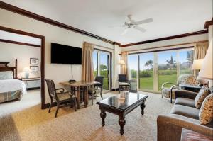 a hotel room with a bed and a living room at Condos in Waipouli Beach Resort in Kapaa