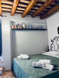 a bedroom with a bed with two towels on it at Cortile Padre Vincenzo in Erice