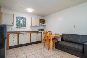 a kitchen with a couch and a table in a kitchen at Croft Inn Motel in Crofton