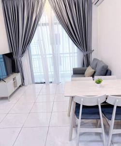 a living room with a table and a couch at TheSun #3BR #PISA #FTZ #FamilyStay #USM in Bayan Lepas