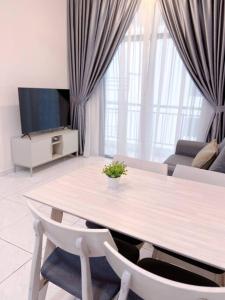 a living room with a table and a tv at TheSun #3BR #PISA #FTZ #FamilyStay #USM in Bayan Lepas