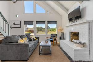 a living room with a couch and a fireplace at Tidal House 2 in Ocean Shores