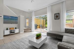 a living room with a couch and a tv at 3 Bedrooms 25 Bathrooms Encantada 3122 Yl in Orlando