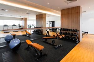 a gym with dumbbells and exercise equipment at Holiday Inn Sepang - Airport in Sepang