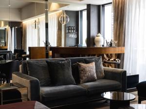 a living room with a couch and a bar at Emporium Hotel South Bank in Brisbane