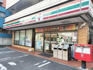a store on the side of a street with several trash cans at Holy Inn in Tokyo