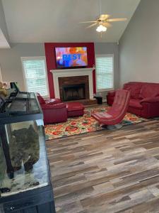 a living room with a couch and a fireplace at Fortress of Solitude in Powder Springs
