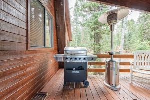 a grill on a deck next to a chair on a porch at Moonlight Ridge in Duck Creek Village
