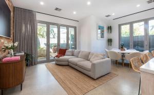 a living room with a couch and a table at The Retreat @ Parkside in Rose Park