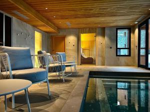 a living room with a swimming pool and chairs at Appartement Les Arcs 1800, 4 pièces, 6 personnes - FR-1-352-85 in Bourg-Saint-Maurice