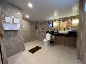 a large bathroom with a toilet and a sink at Palm Leaf Resort Koh Tao in Ko Tao