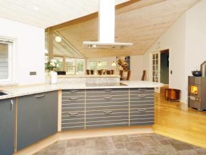 a kitchen with blue and white cabinets and a counter top at 10 person holiday home in R dby in Rødby