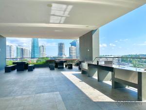 a building with a balcony with a view of the city at SKS Pavillion Residences by Stayrene in Johor Bahru