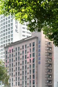 a building with writing on it in front of buildings at CYBO Station Luohu Shenzhen in Shenzhen