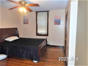 a bedroom with a bed and a ceiling fan at The Quiet Place in St.Louis in Tower Grove