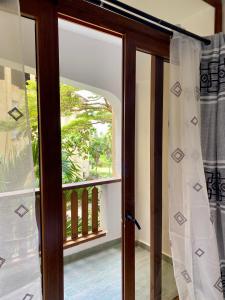 an open door with a view of a balcony at Beachfront Studio-Waves & Wanderlust Haven in Mombasa