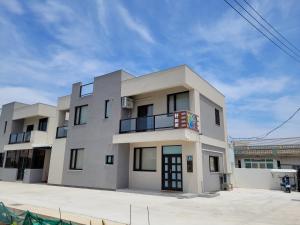 a large white building with a sky at Penghu Good together Villa in Magong
