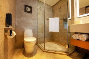 a bathroom with a shower and a toilet and a phone at Renaissance Beijing Wangfujing Hotel in Beijing