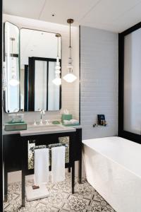 a bathroom with a tub and a sink and a mirror at Chengdu Wangjiang Hotel in Chengdu