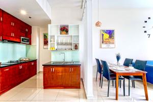 a kitchen and dining room with a table and chairs at RiverGate Residence Apartment - The Origin in Ho Chi Minh City