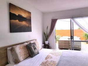 a bedroom with a bed and a large window at Alice House in Auckland