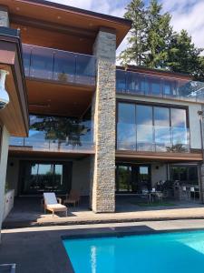 an exterior view of a house with a swimming pool at Luxury accomodation in West Vancouver in West Vancouver