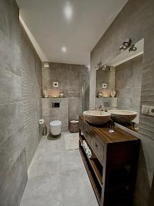 a bathroom with two sinks and a toilet at Luxury Apartment in Rzeszów