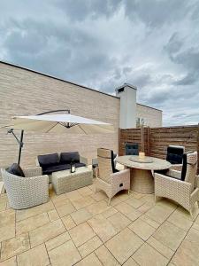 a patio with a table and chairs and an umbrella at Luxury Apartment in Rzeszów