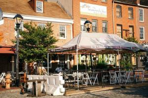a restaurant with a tent in front of a building at Sleek and Cozy Micro Fells Point Residence! in Baltimore