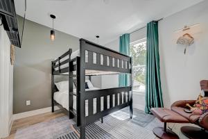 a bedroom with a black bunk bed and a chair at Victoria Island Palace Toyota Center Downtown Houston in Houston