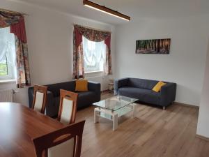 a living room with a couch and a table at Ferienhaus Schöller in Schönbach