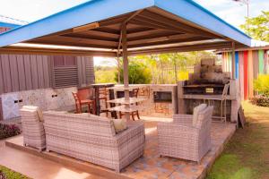 a pavilion with chairs and a table and a grill at Tahals Holiday Villas in Nadi