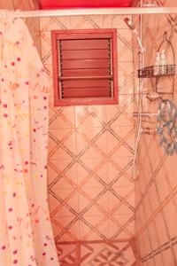 a shower with a window and a shower curtain at Tahals Holiday Villas in Nadi