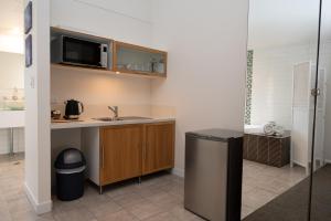 a small kitchen with a sink and a microwave at Prideau's of Margaret River in Margaret River Town