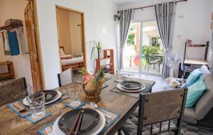 a dining room with a wooden table and chairs at Enda Lanta Bungalows in Ko Lanta