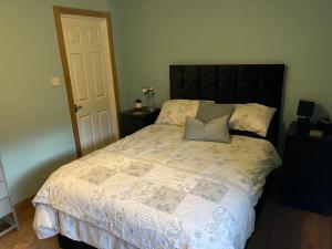 a bedroom with a large bed with two pillows at bailiffs cottage annex in Doncaster