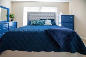 a bedroom with a blue bed and blue dressers at Large 3BR King Suite Moments Away From Strip in Las Vegas