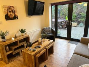 a living room with a couch and a table at bailiffs cottage annex in Doncaster