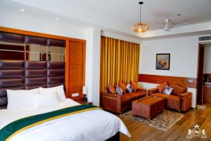 a hotel room with a bed and a couch at Hotel A9 Barnala in Barnāla