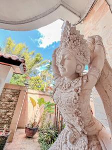 une statue d'une femme debout sur un patio dans l'établissement Villa Tentram Jimbaran by Bali Cabin, à Jimbaran
