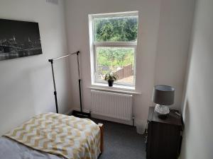 a bedroom with a bed and a window at 5 Fernie ave contractor home in center of Melton Mowbray in Melton Mowbray