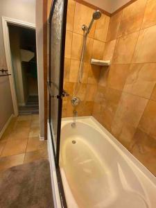 a bath tub in a bathroom with a shower at Cozy Coastal Condo in Corpus Christi