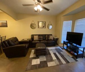 a living room with a couch and a flat screen tv at Cozy Coastal Condo in Corpus Christi